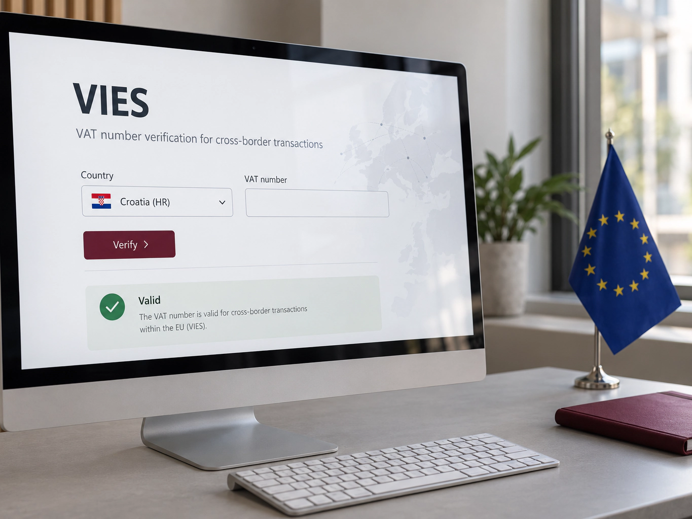 Un monitor con la verifica VIES di una partita IVA croata, accanto a una bandiera dell’Unione europea